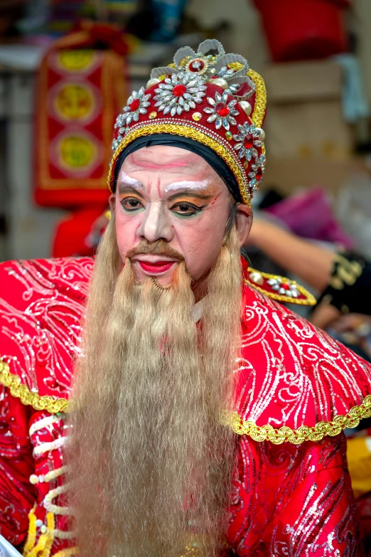 a man in a red costume with gold decorations