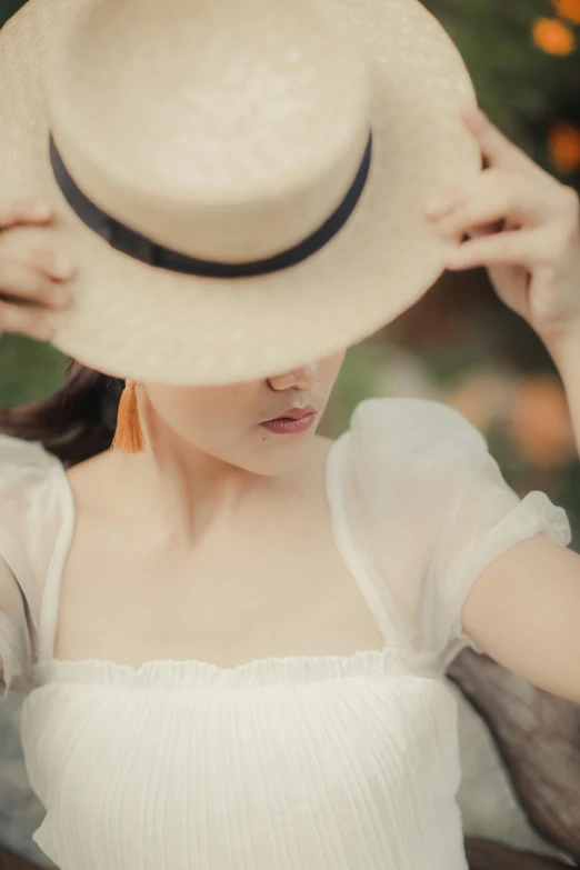 a woman holds her hat above her head