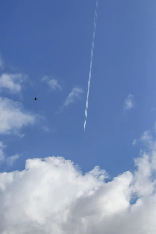 an airplane is flying through the clouds on a sunny day