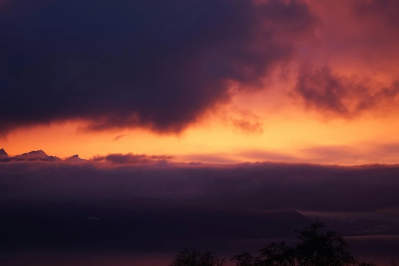 a large body of water in the distance and clouds above it