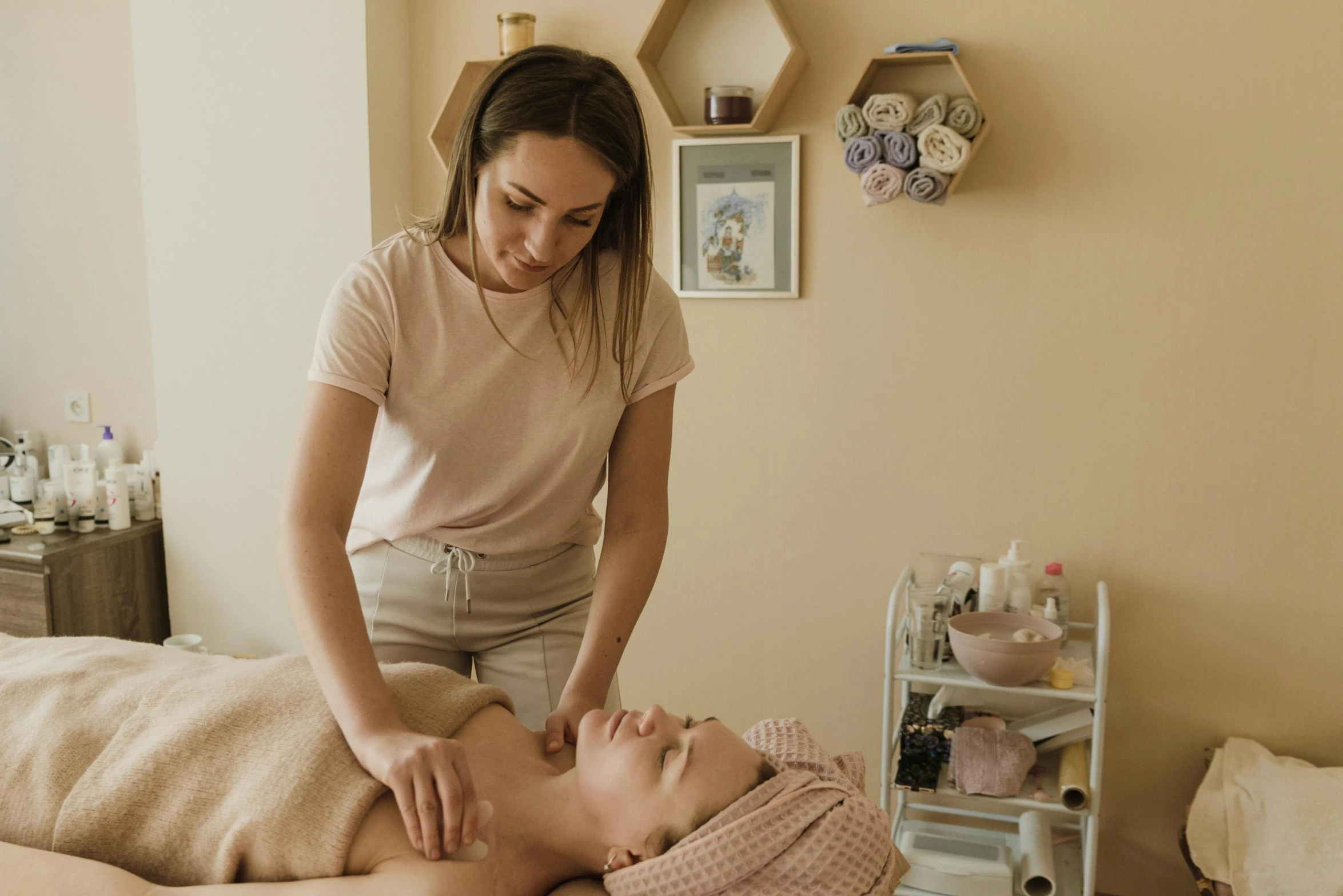 a lady is shown giving a girl the facial massage