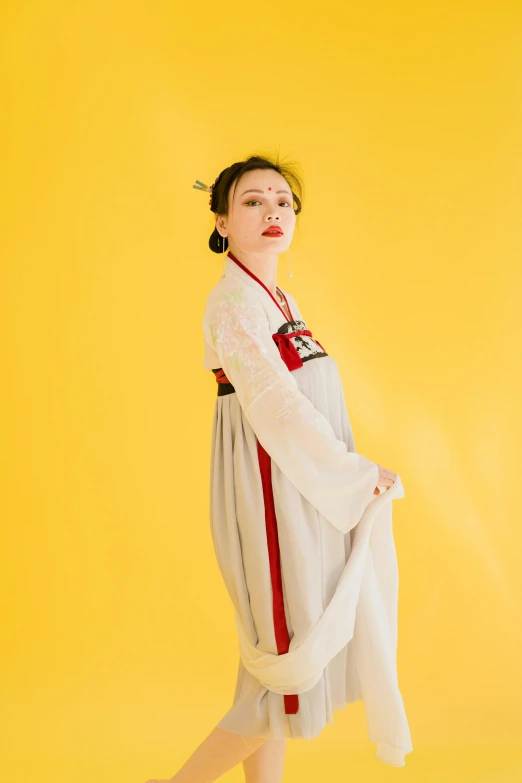 a woman posing for a po wearing an oriental dress