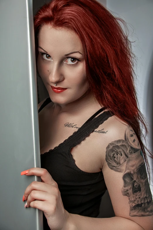 a pretty redhead woman with red hair holding a fridge