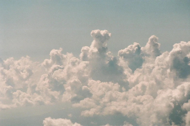 some clouds in the sky and green grass