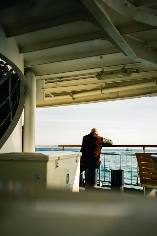 a person standing on a boat with his hands together