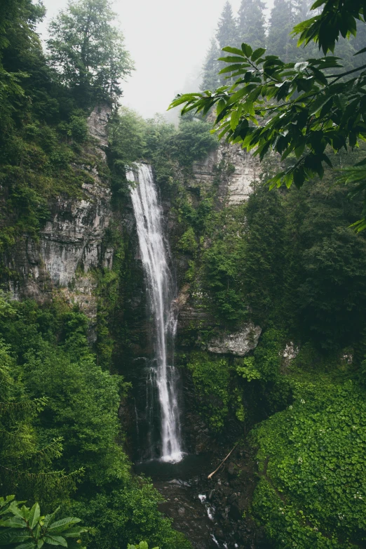 a large waterfall that is in a wooded area