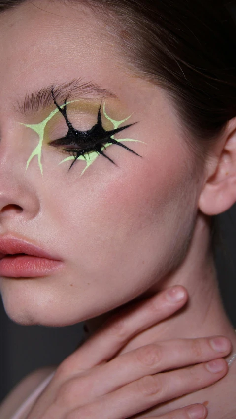 close up s of woman with eye makeup and nails