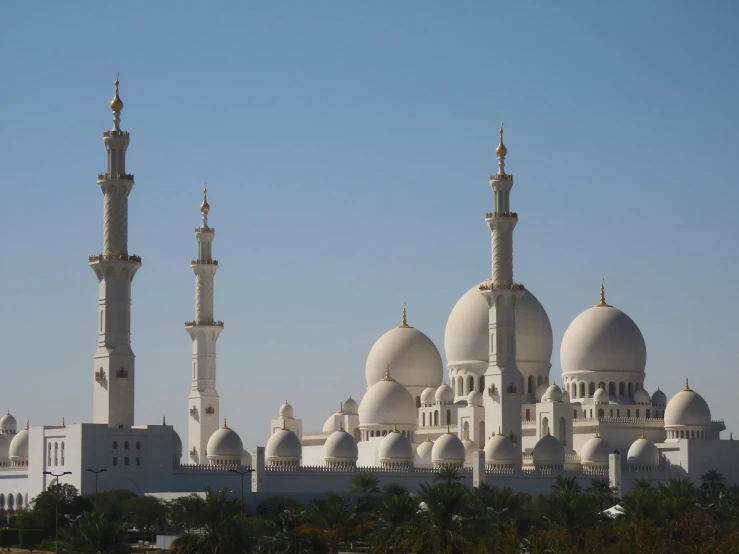 a tall white building with multiple domes and pillars