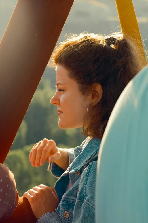 woman holding steering wheel of a vehicle while the sun is setting