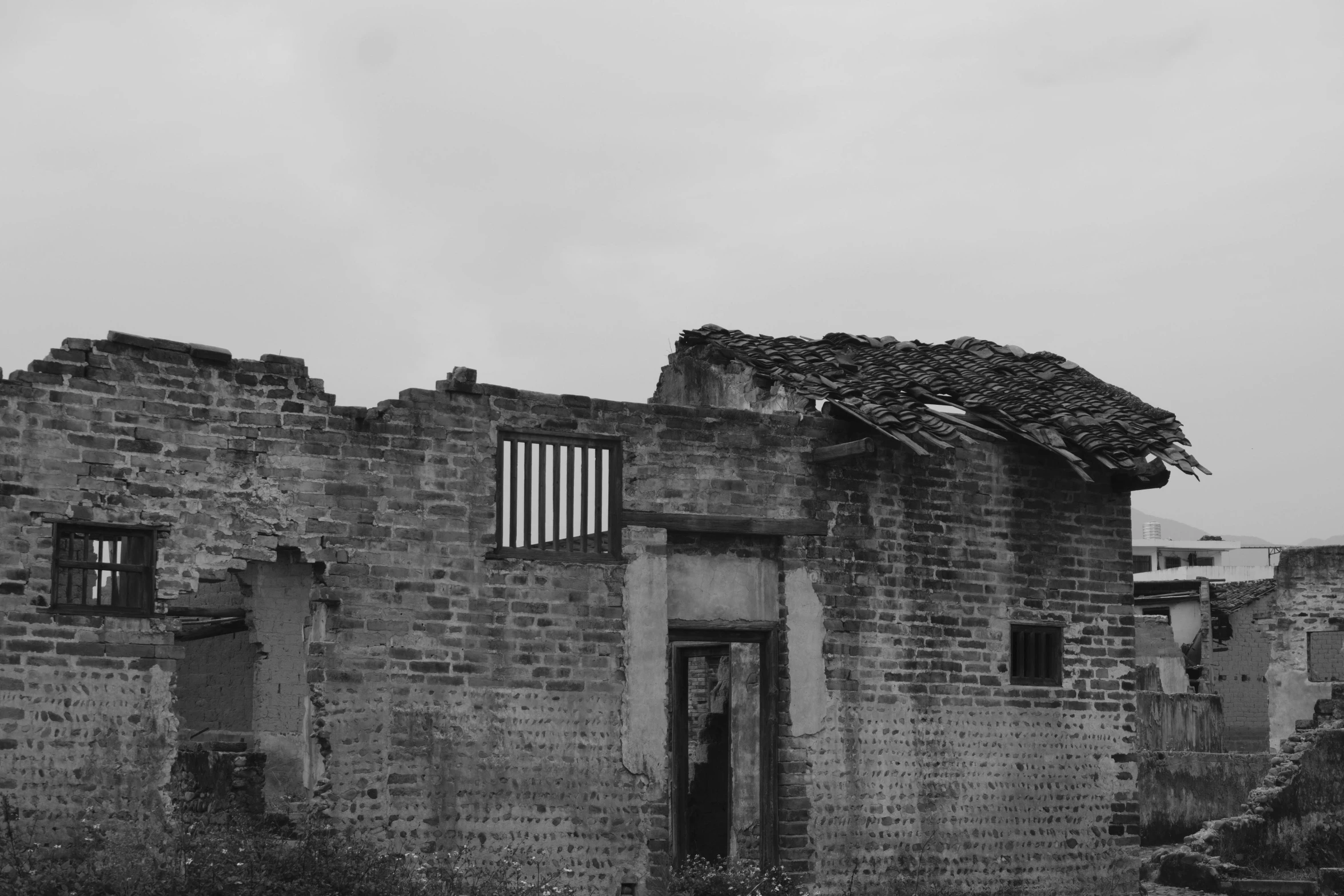 an old house with multiple windows, made of bricks