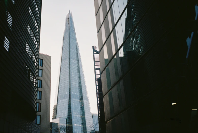 a tall skyscr is near other buildings