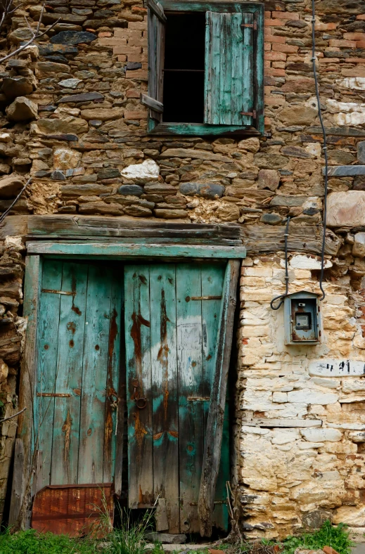 a brick building has a blue door and window