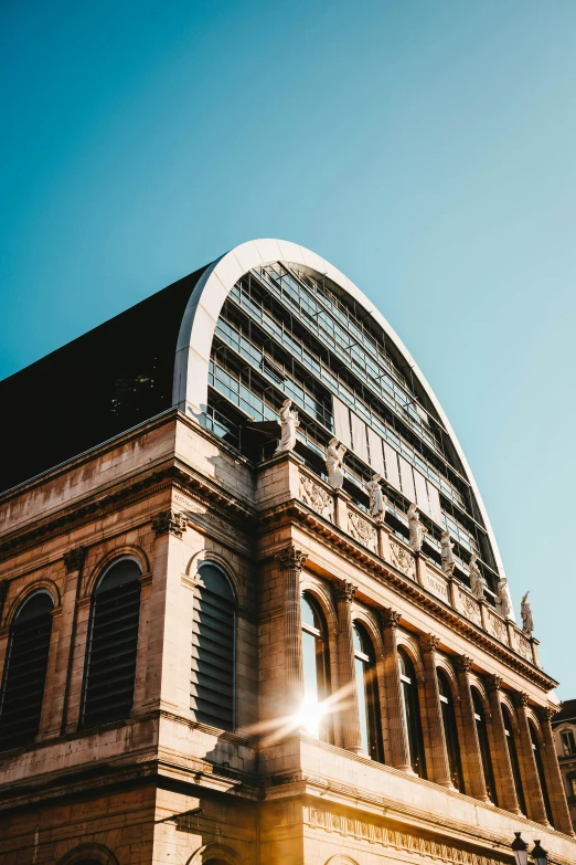 sunlight shines through windows in front of the structure on top of an old building