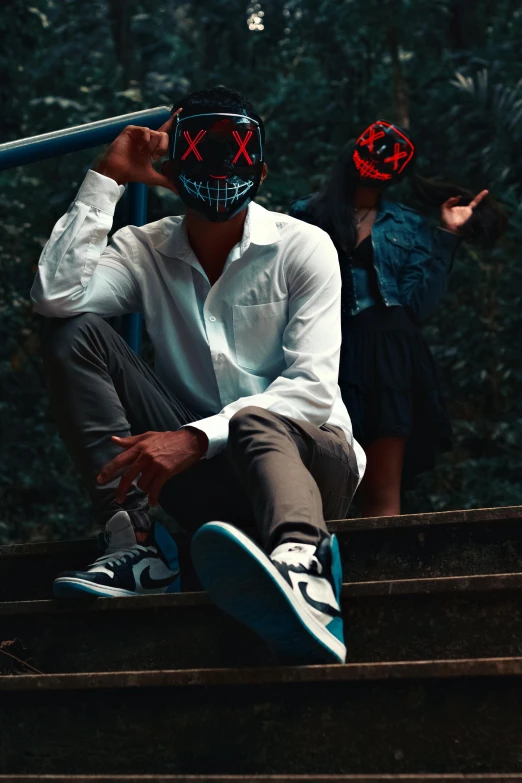 a young man holding onto a skateboard and a pair of scissors