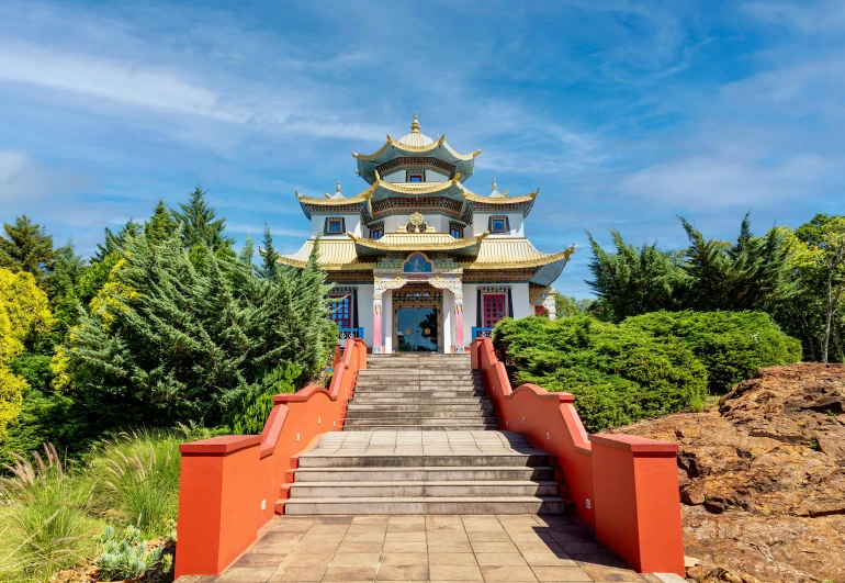 the entrance to an orange and white chinese style building