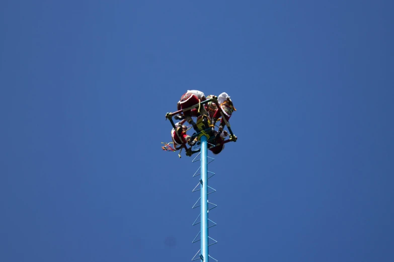 a man riding a ride on the back of a carnival machine