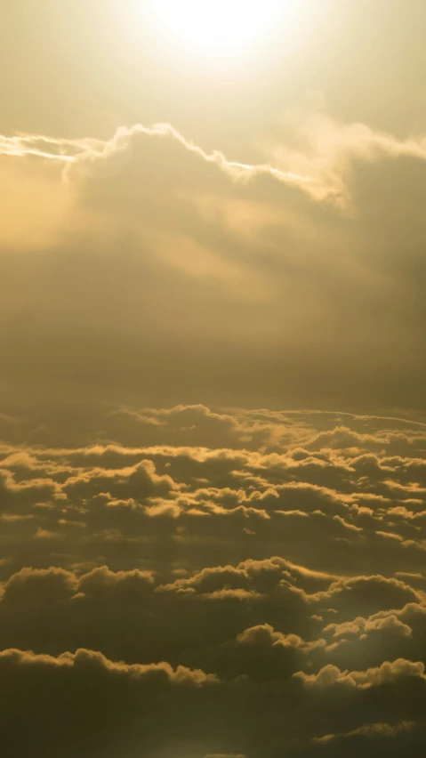 the sun shining through the clouds in a gray sky