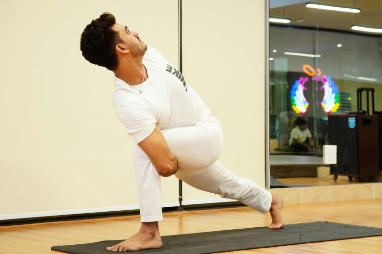 a man practicing yoga inside of a room