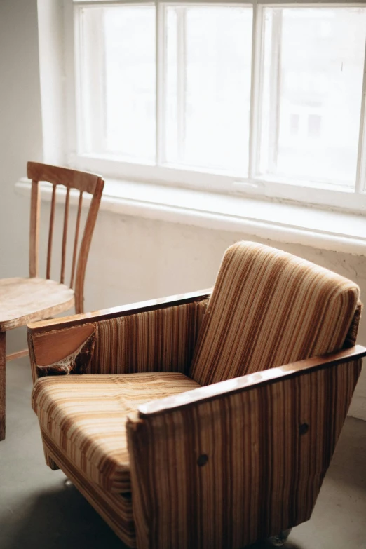 two chairs next to each other near a window