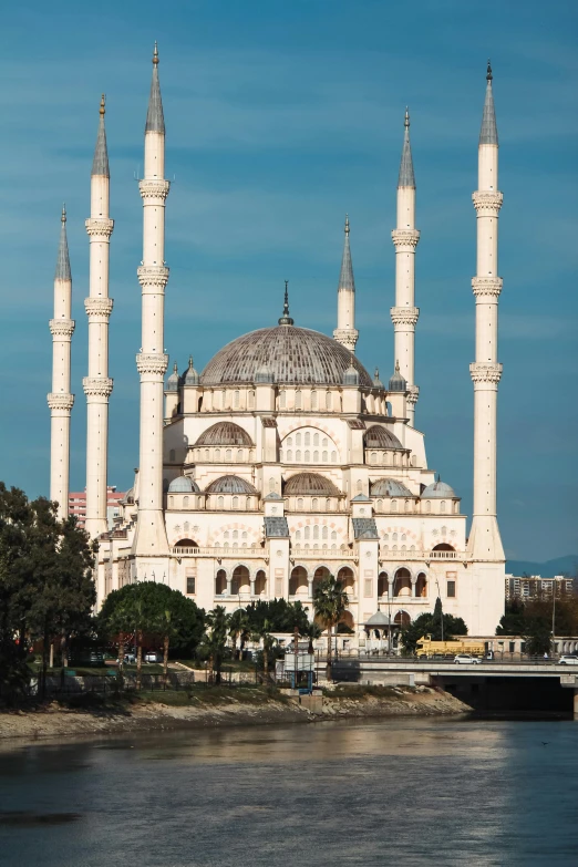 a blue and white cathedral on water and trees