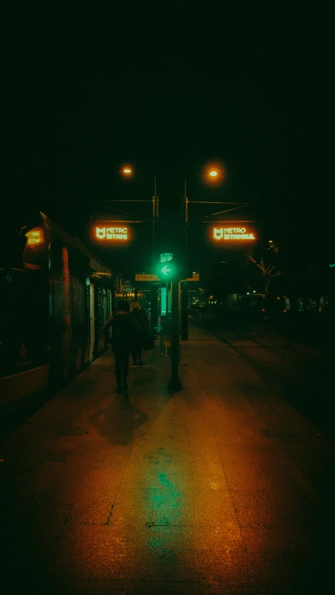 a nighttime time scene showing a green street light