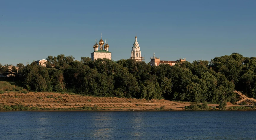 the towers are tall above the trees on the bank