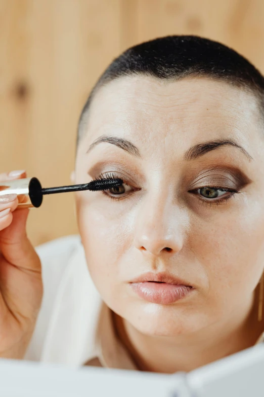 a woman that has a mascara in her hand