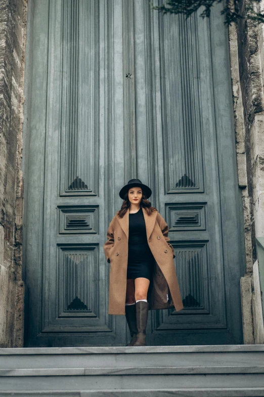 a woman standing on the steps of an entrance