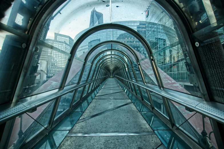 several rows of glass and steel railings at the entrance to a subway