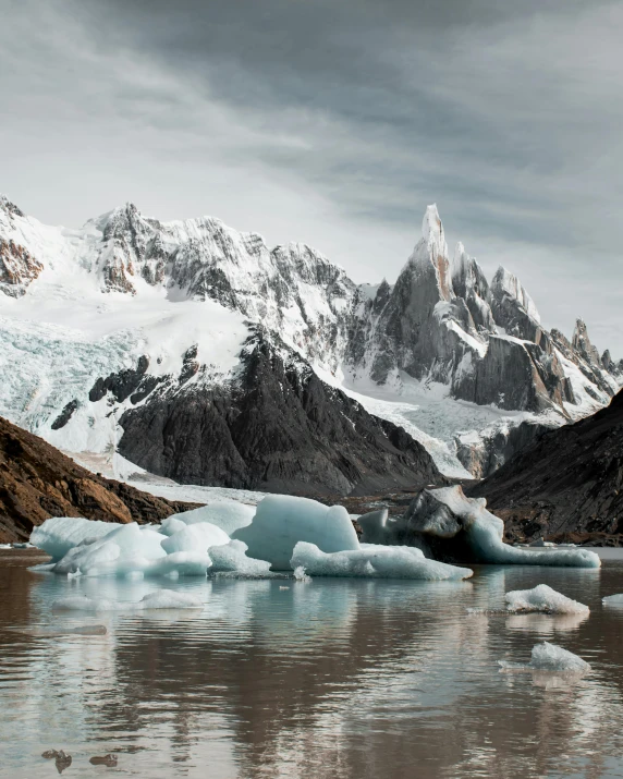 the mountains and ice are reflected in the water