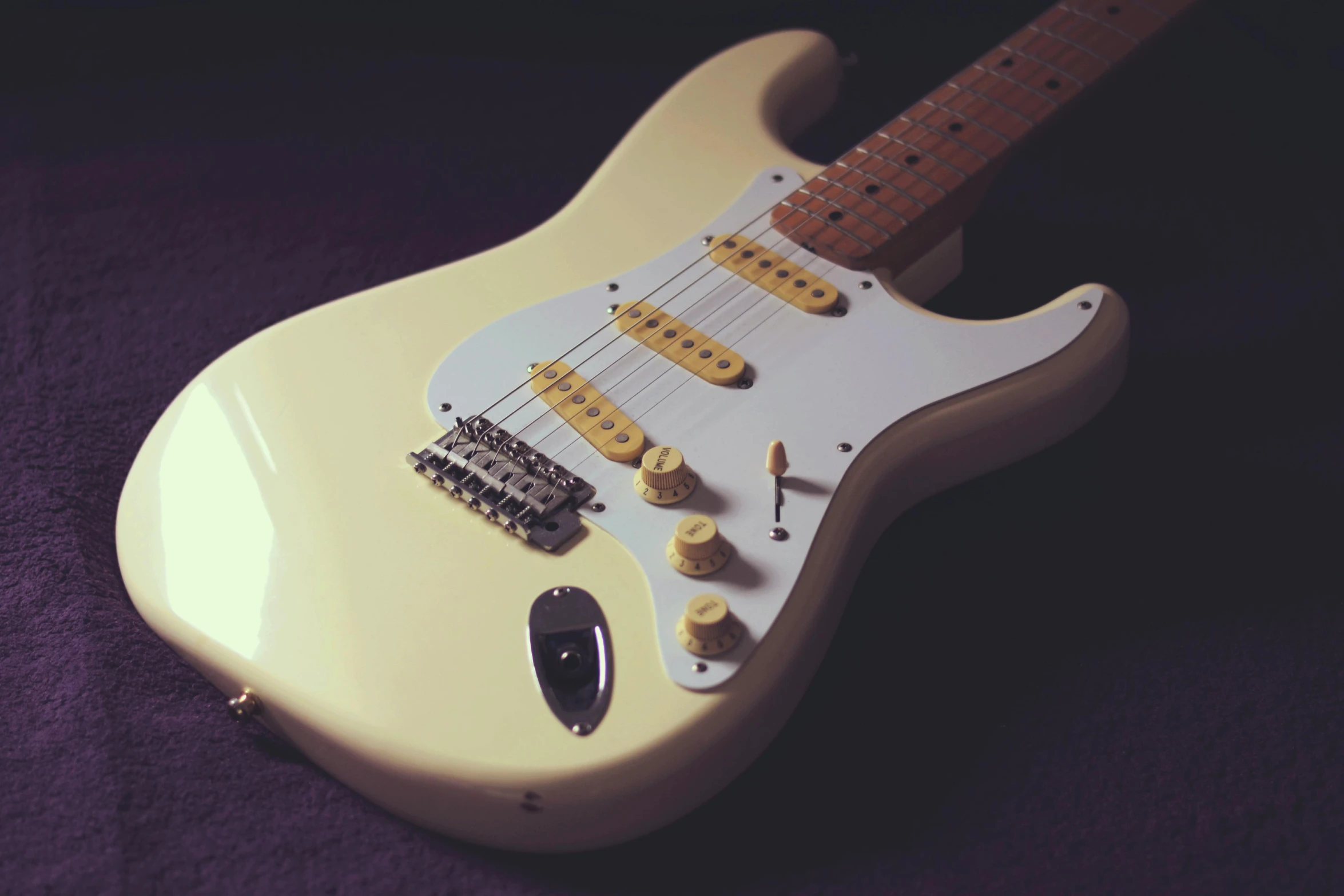 the fender electric guitar has a white finish