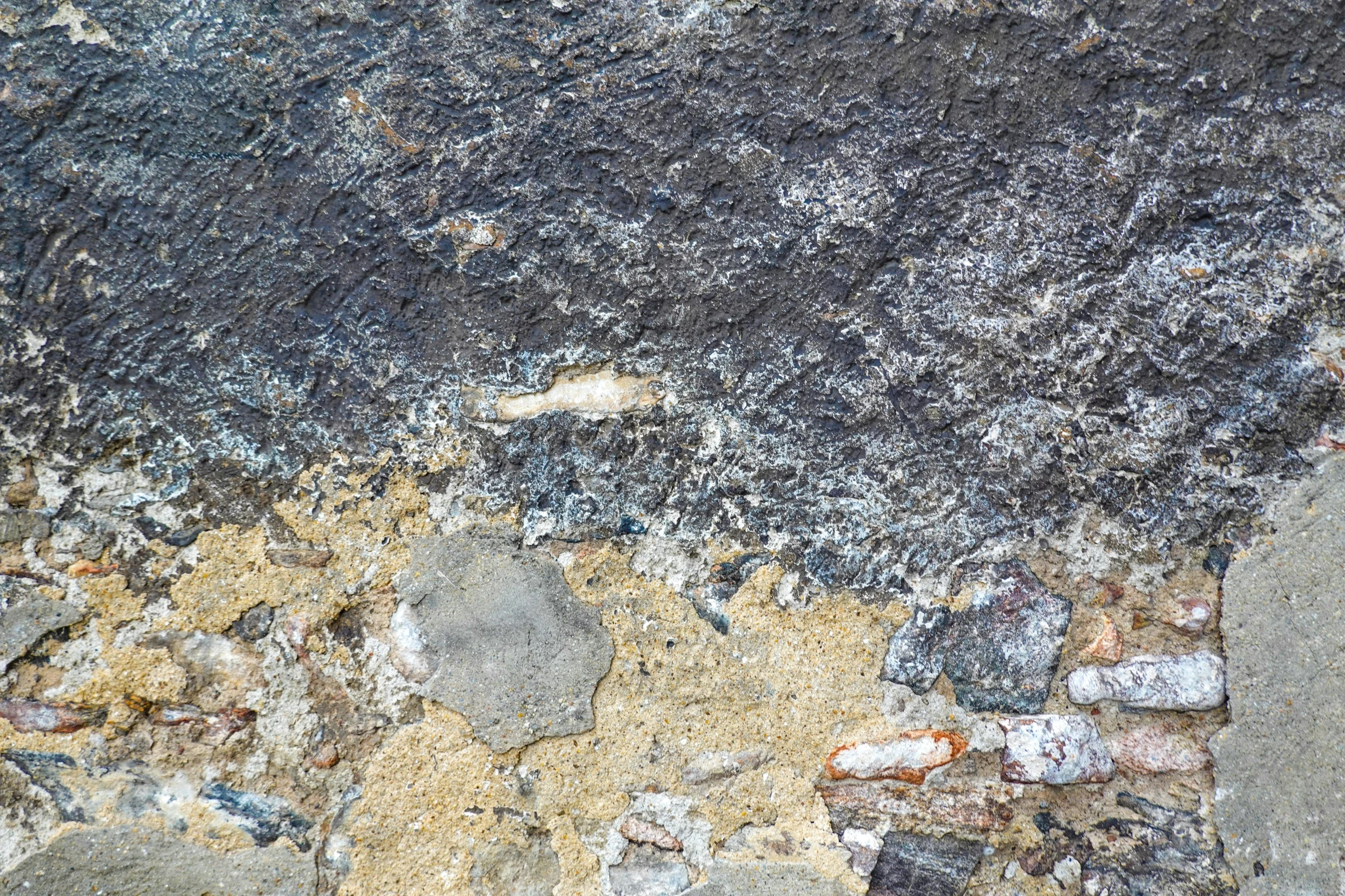 a piece of grey, yellow and gray rock wall