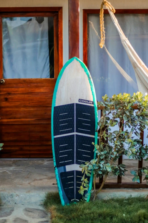 the underside of a surfboard is leaning up against a railing
