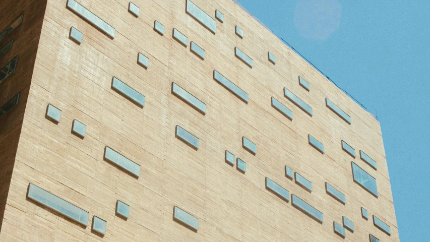 a building with some windows has a sky background