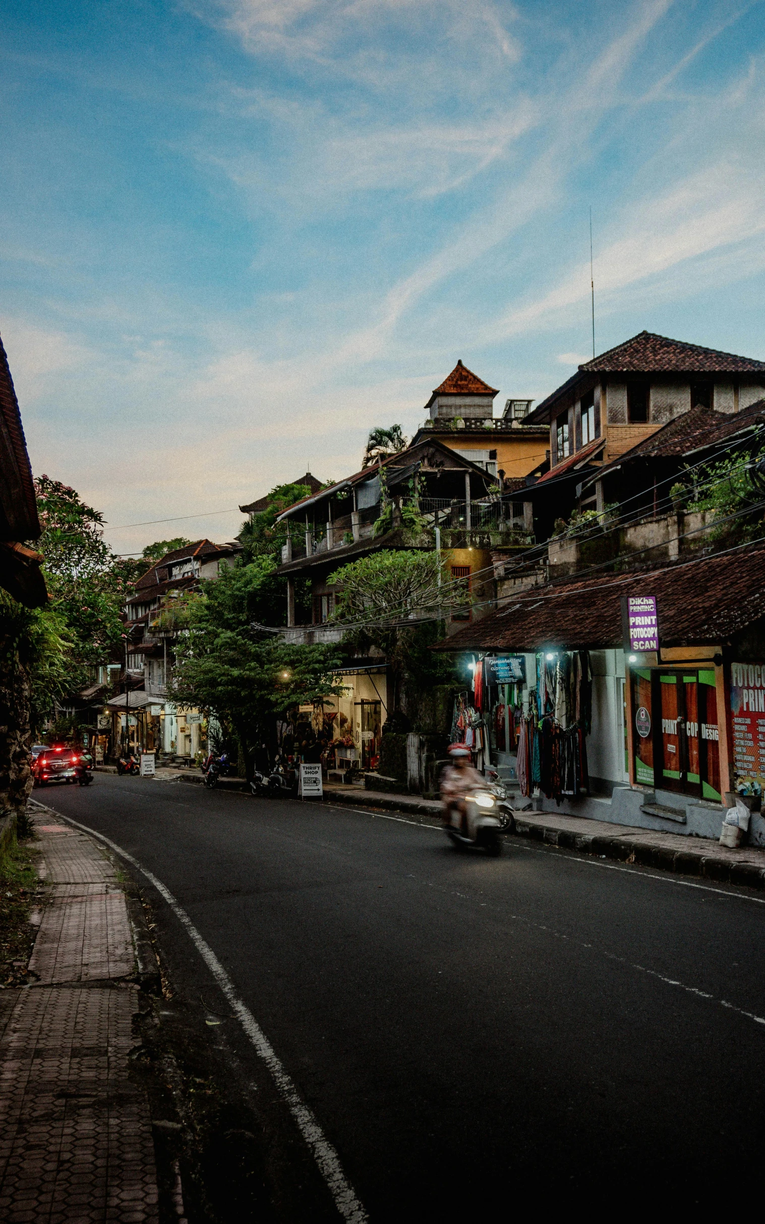 two cars drive through the empty street of the city