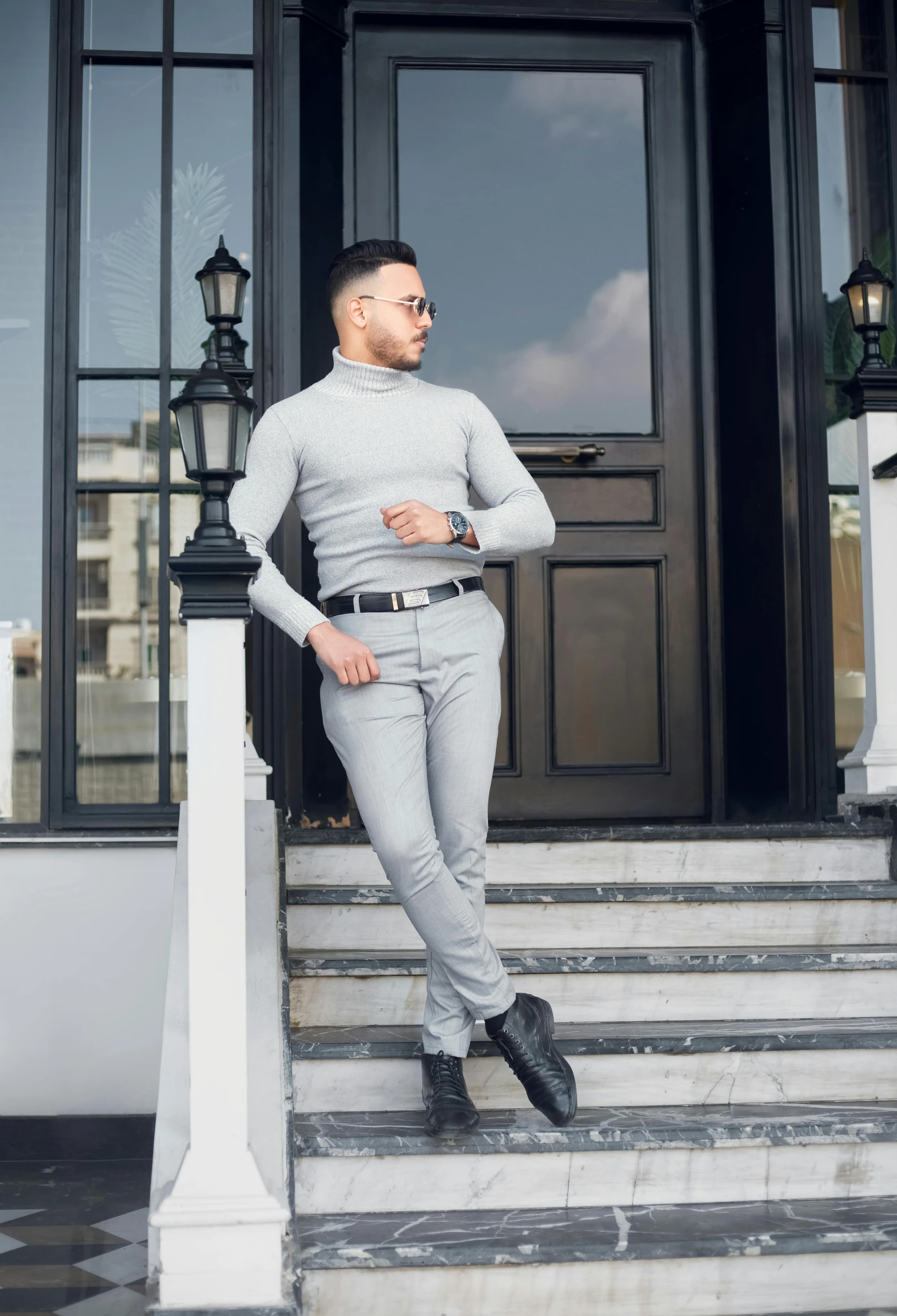 a man standing on the steps in front of a building