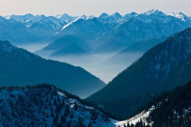 a blue sky and some snow covered mountains