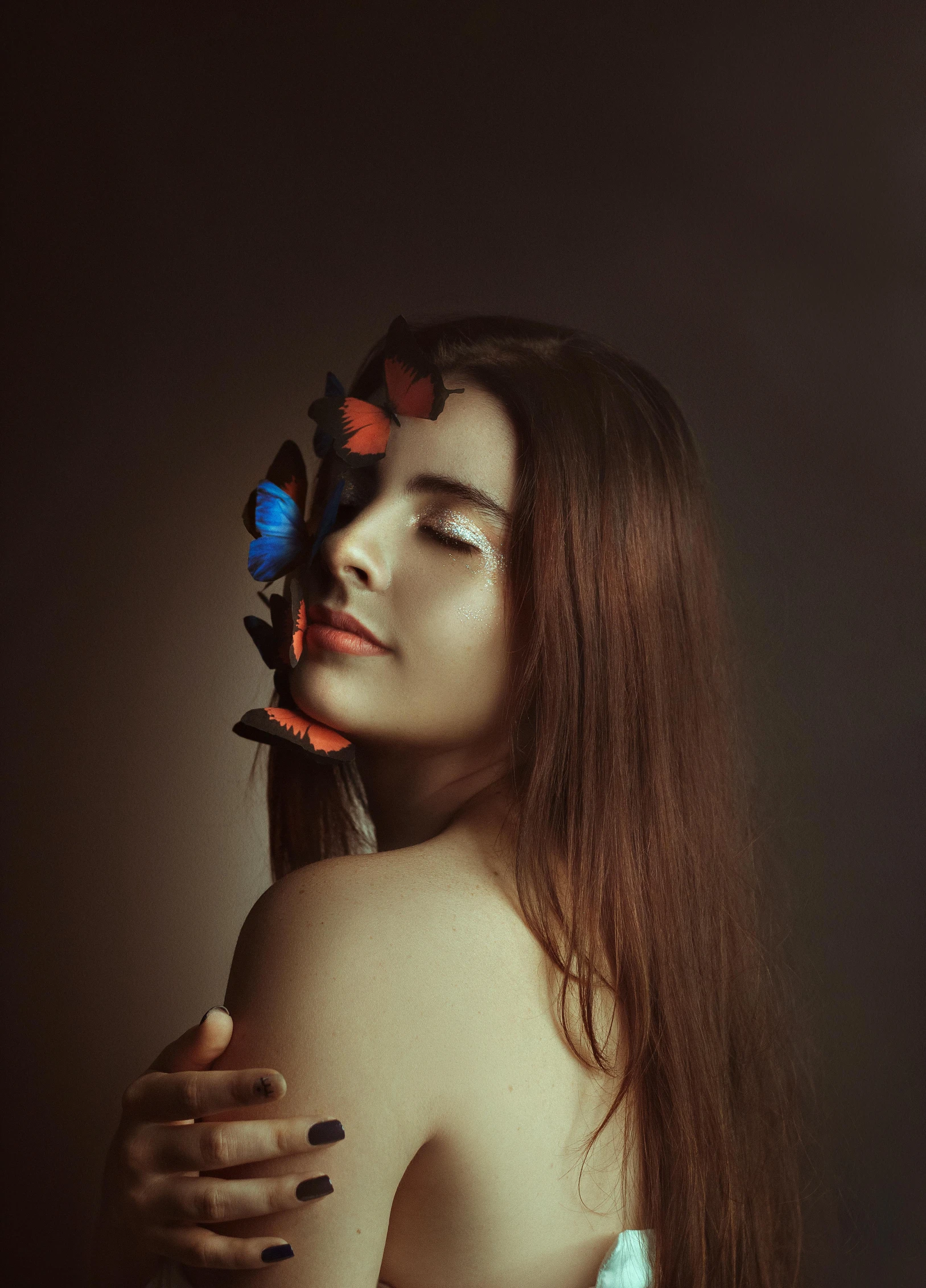 woman in white top and flowers on her face posing for po shoot