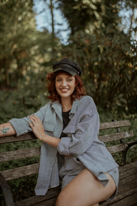 the woman is posing on a bench for a po