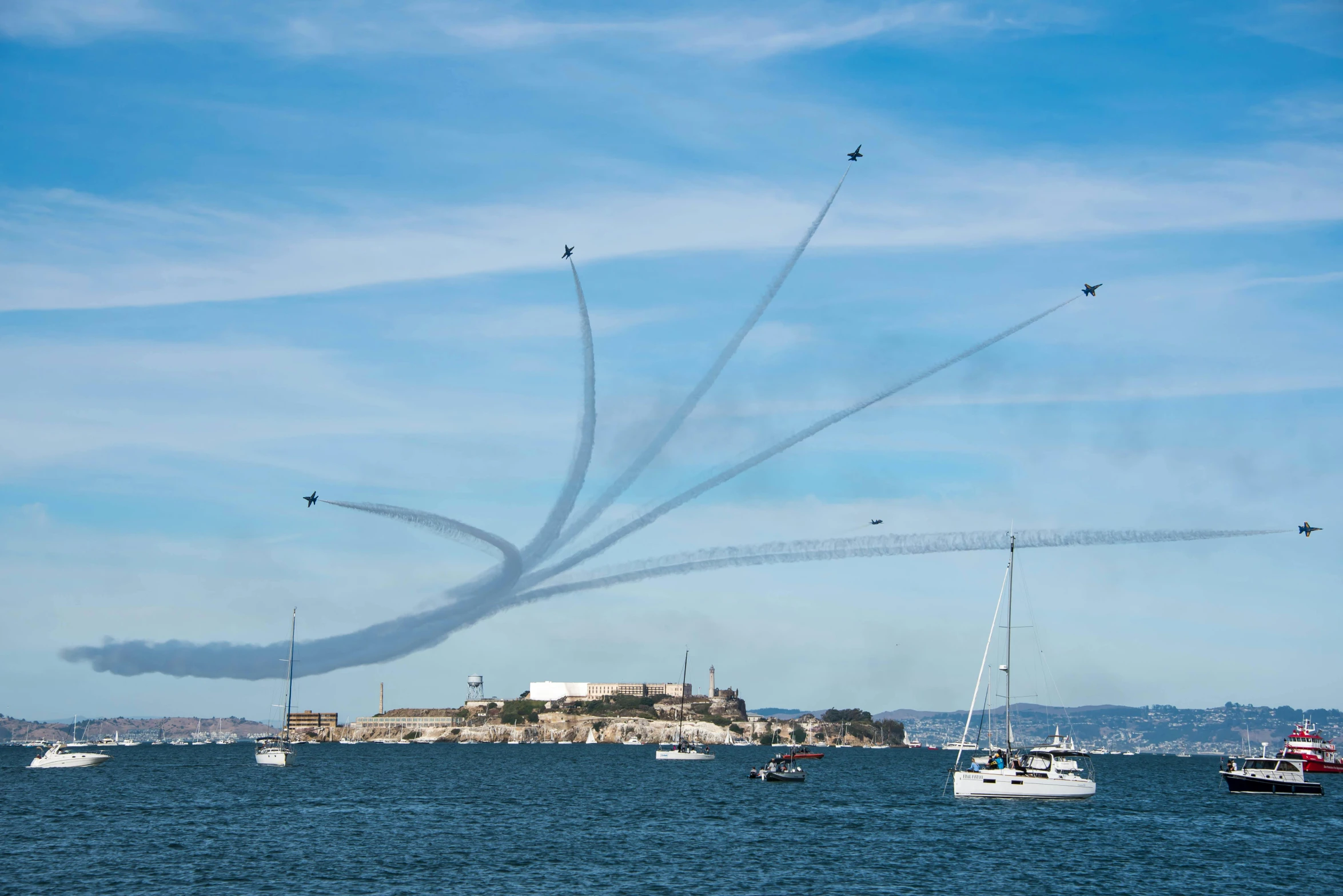 some airplanes flying in the air near a beach