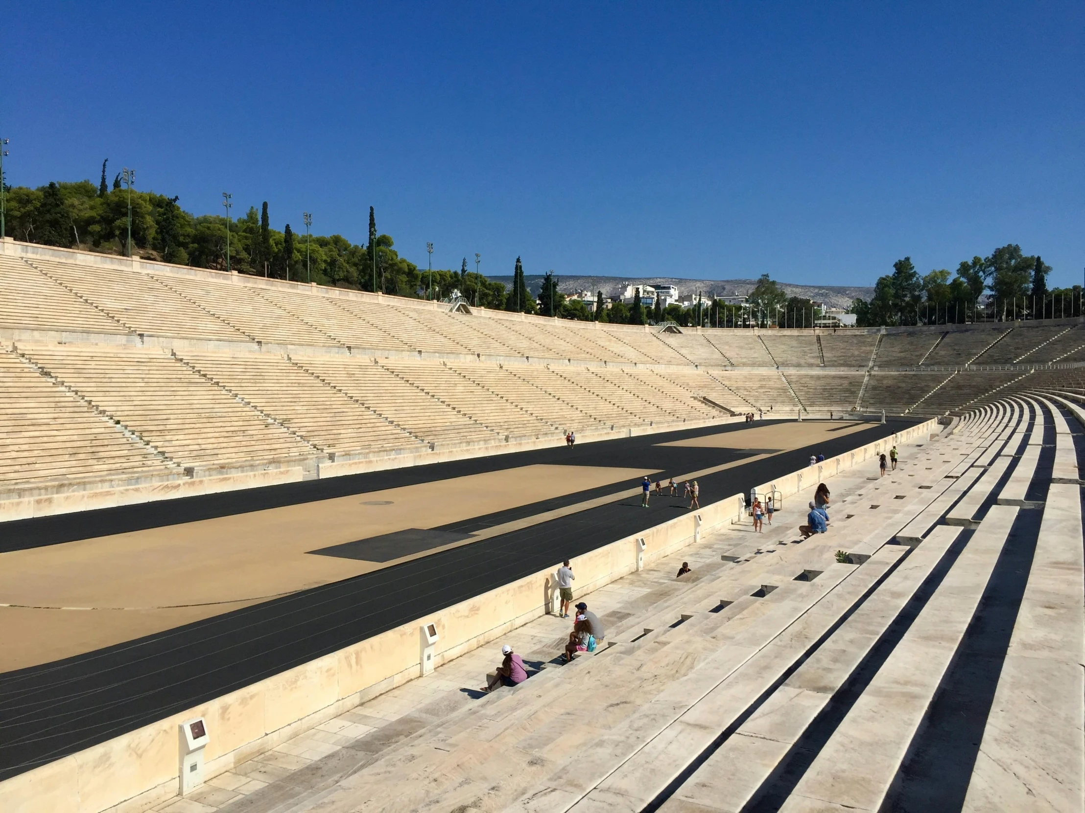 people sitting at an empty stadium, while on the bench