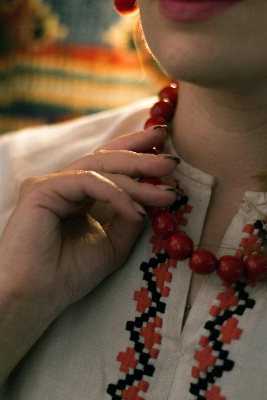 closeup of woman wearing red necklace on head