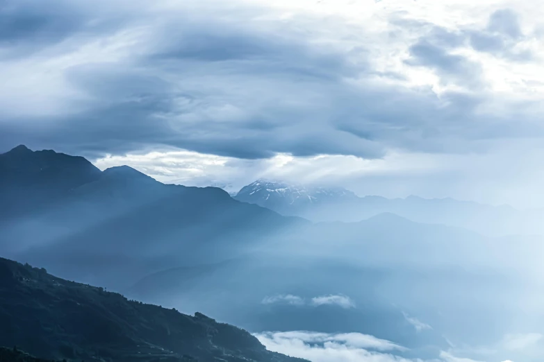 there are some mountains and clouds in the sky