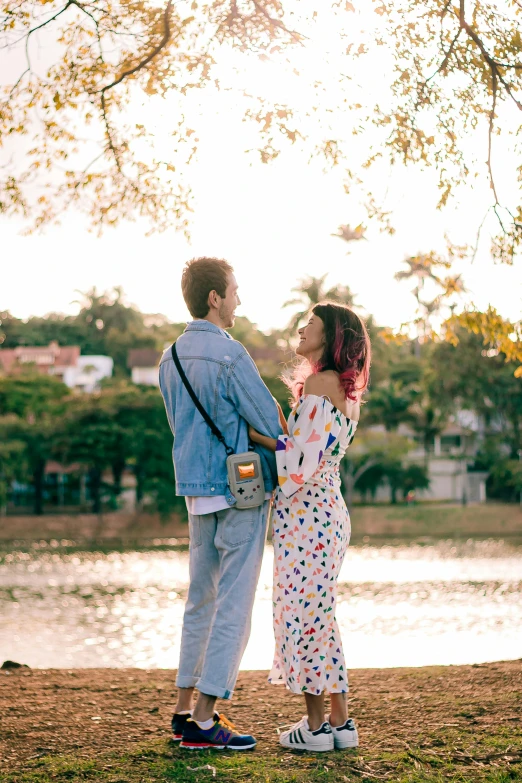 the young man and woman are standing close together