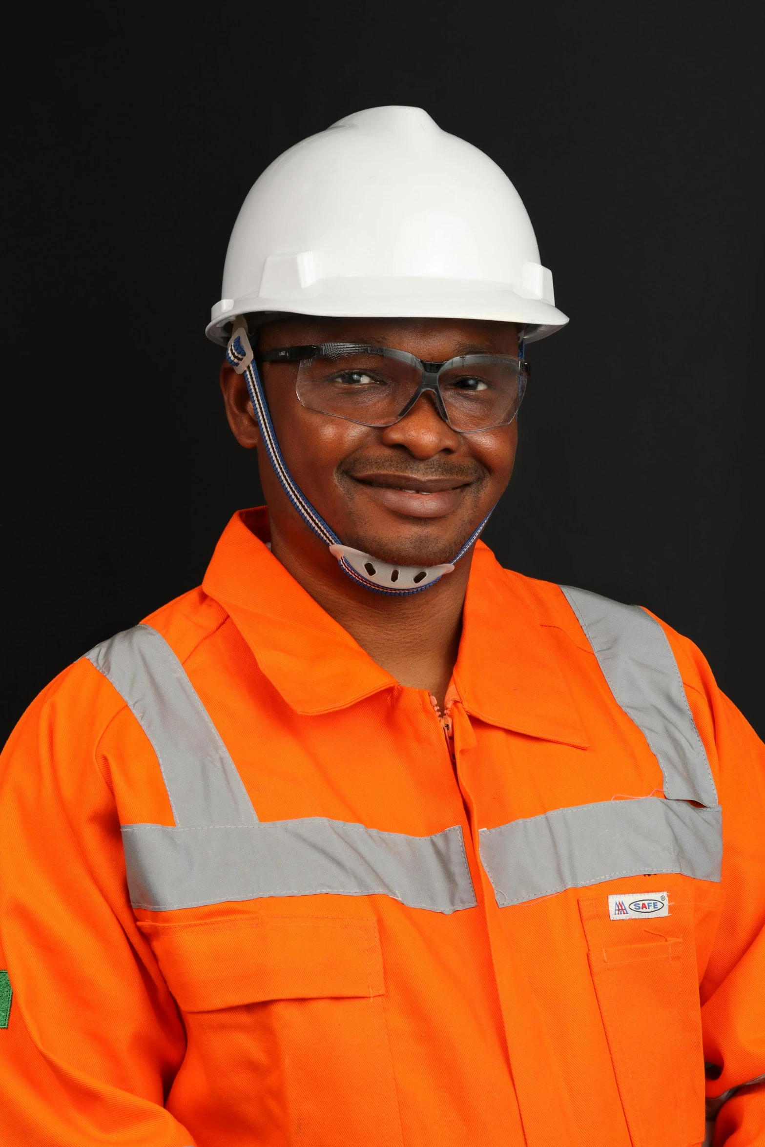 a worker with an orange shirt and white hard hat