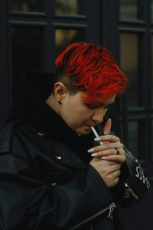 a red haired man with red hair is smoking a cigarette