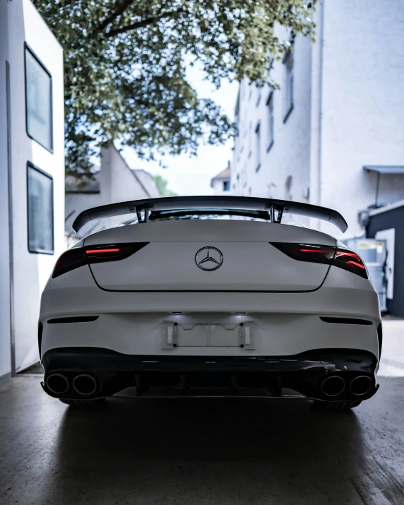 white mercedes coupe is parked in the garage