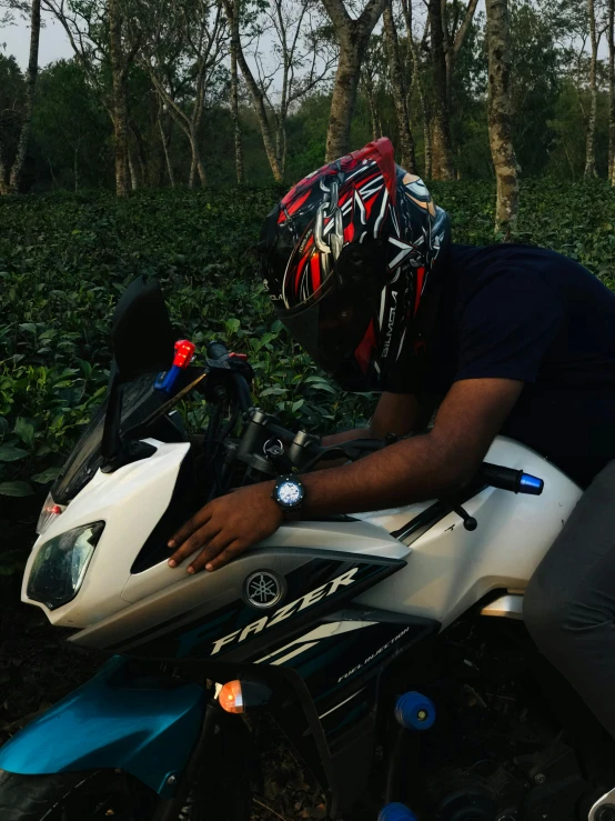 person on motorbike with helmet leaning over