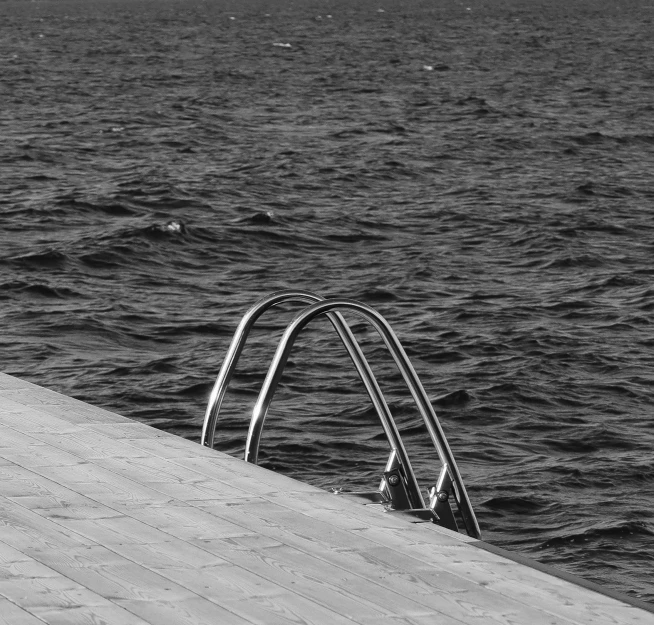 black and white image of steps near the water