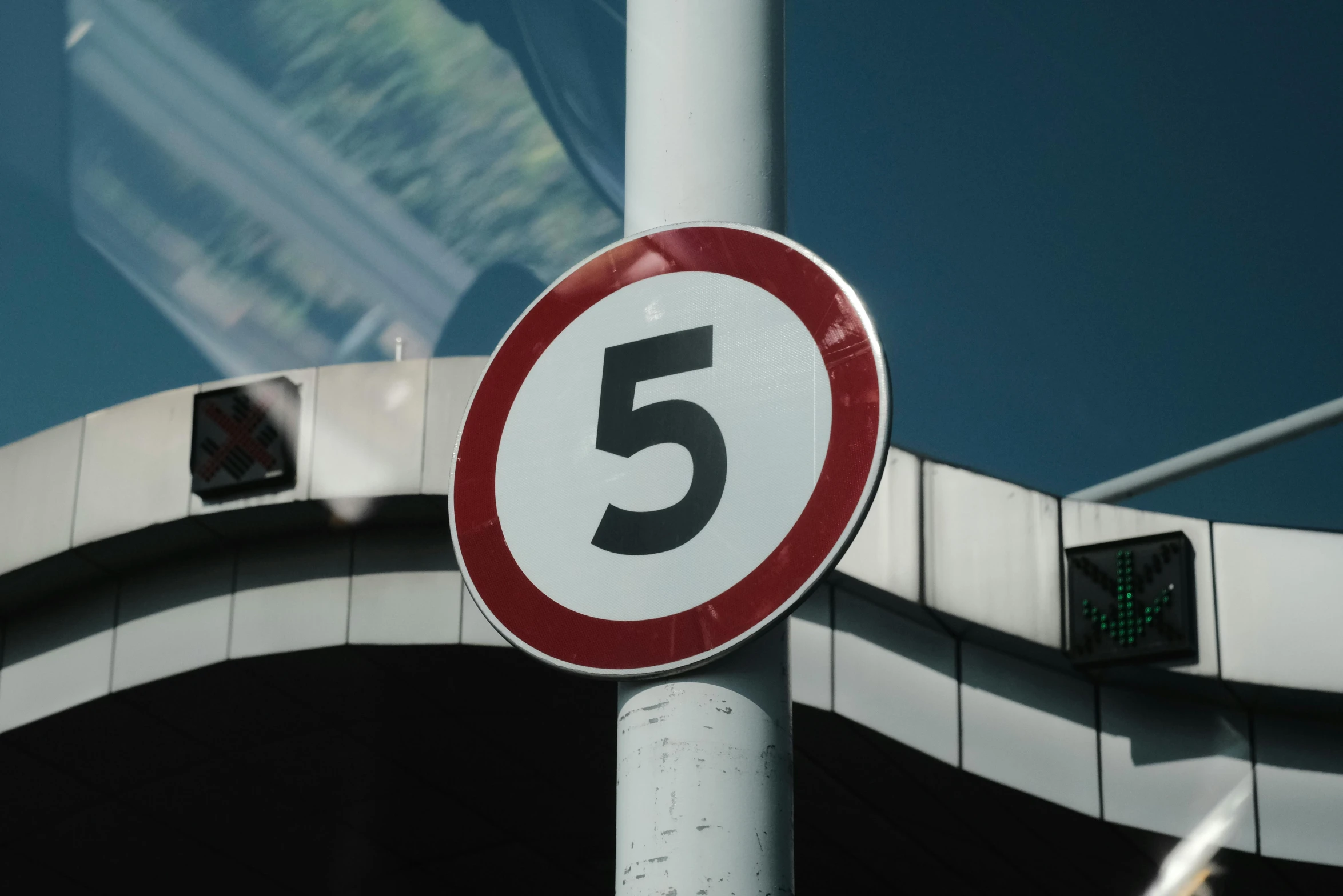 an intersection with traffic signals, the number five